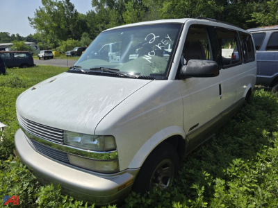 Chevrolet Astro cargo/passenger van in a grassy lot with front grille and headlights visible