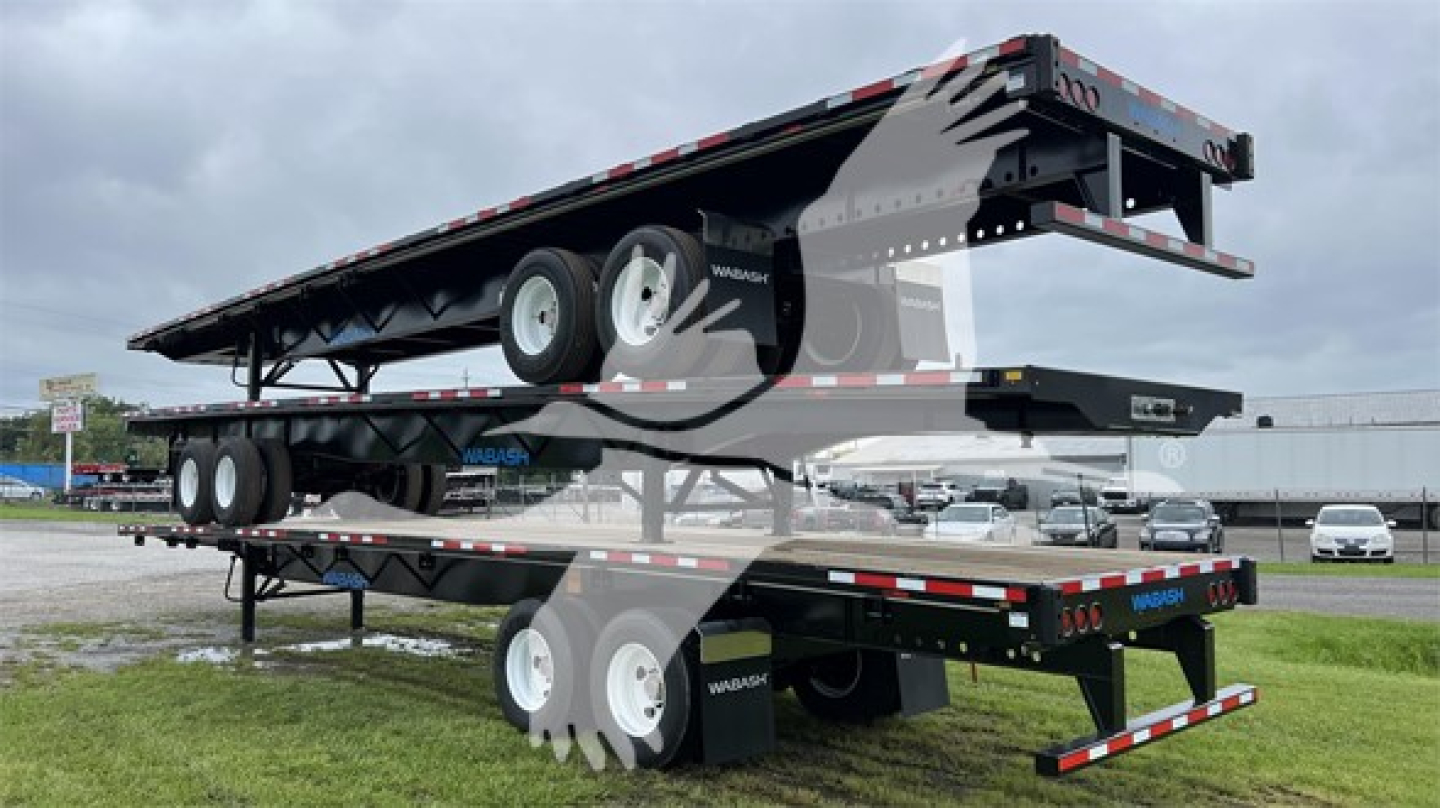 Trailer stack: a Wabash steel spring slider flatbed trailer with dual axles and undercarriage visible.