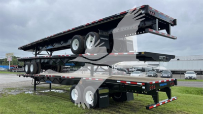 Trailer stack: a Wabash steel spring slider flatbed trailer with dual axles and undercarriage visible.