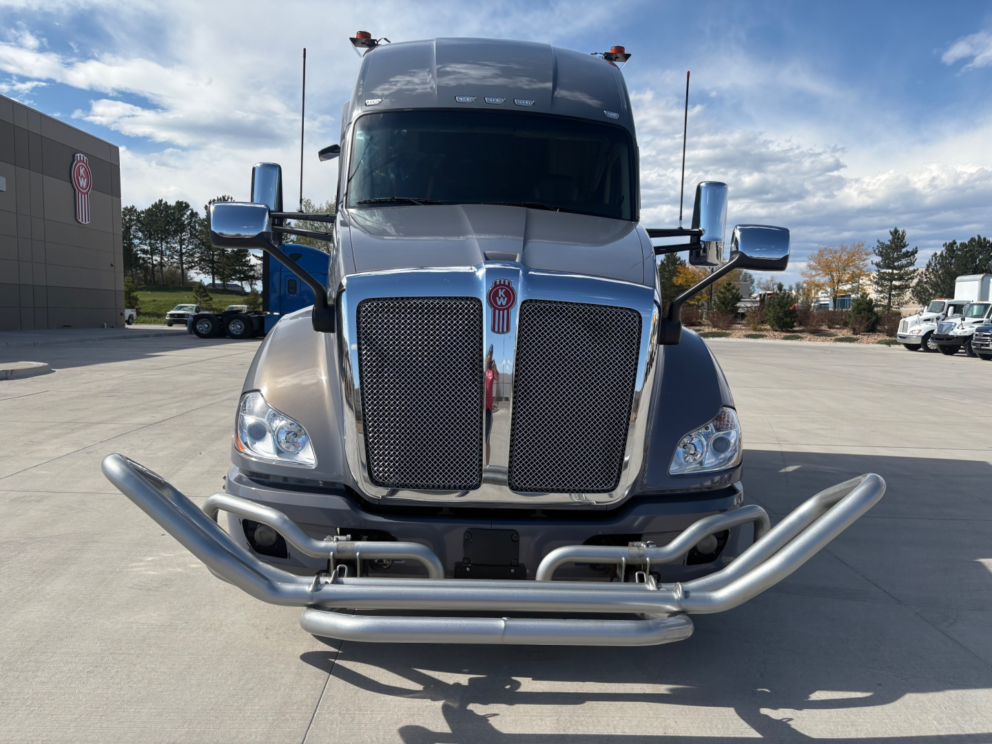 Kenworth T680 truck front view showing chrome grille, dual bumper guard, and large bumper bull bar.
