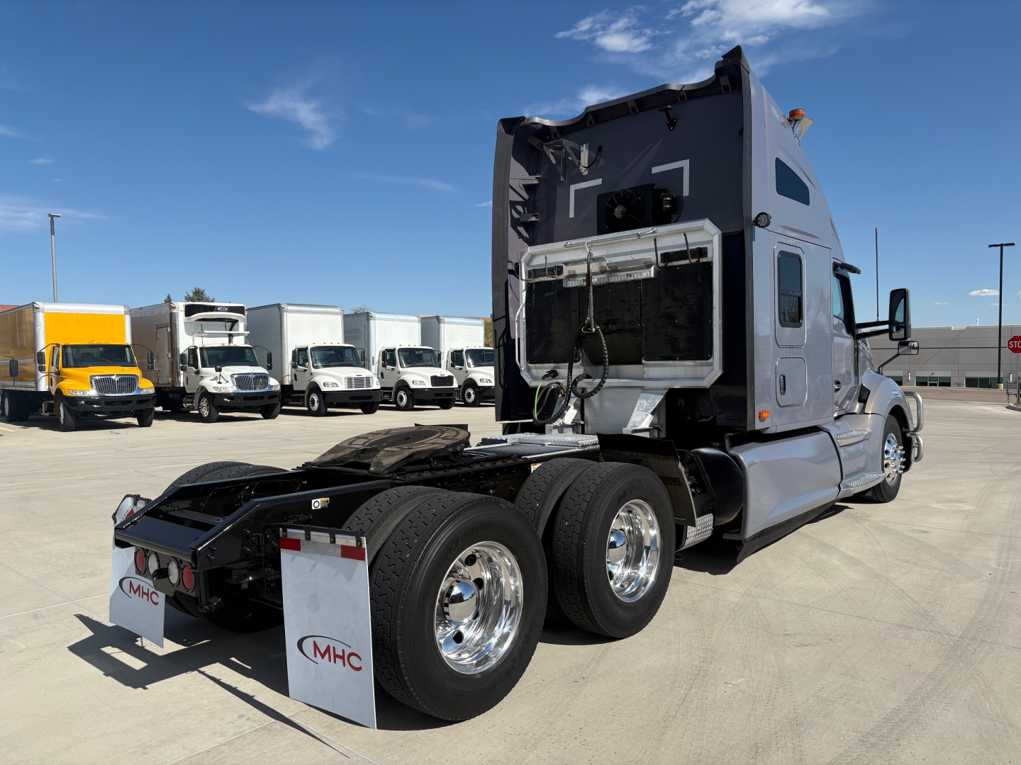 Kenworth T680 tractor with sleeper cab, rear view showing dual rear axles, chrome wheels, and fifth wheel hitch. VIN and stock not visible on image.