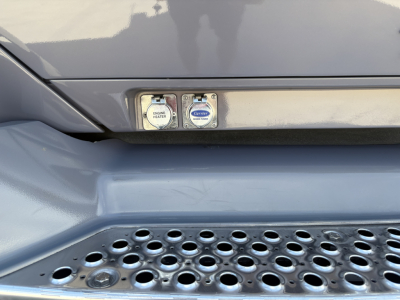 Kenworth T680 entry area showing two control switch panels, with labels reading 'ENGINE WATER' and 'CAB HEATER' or similar under the hood area.