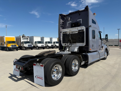 Kenworth T680 tractor with sleeper cab, rear view showing dual rear axles, chrome wheels, and fifth wheel hitch. VIN and stock not visible on image.