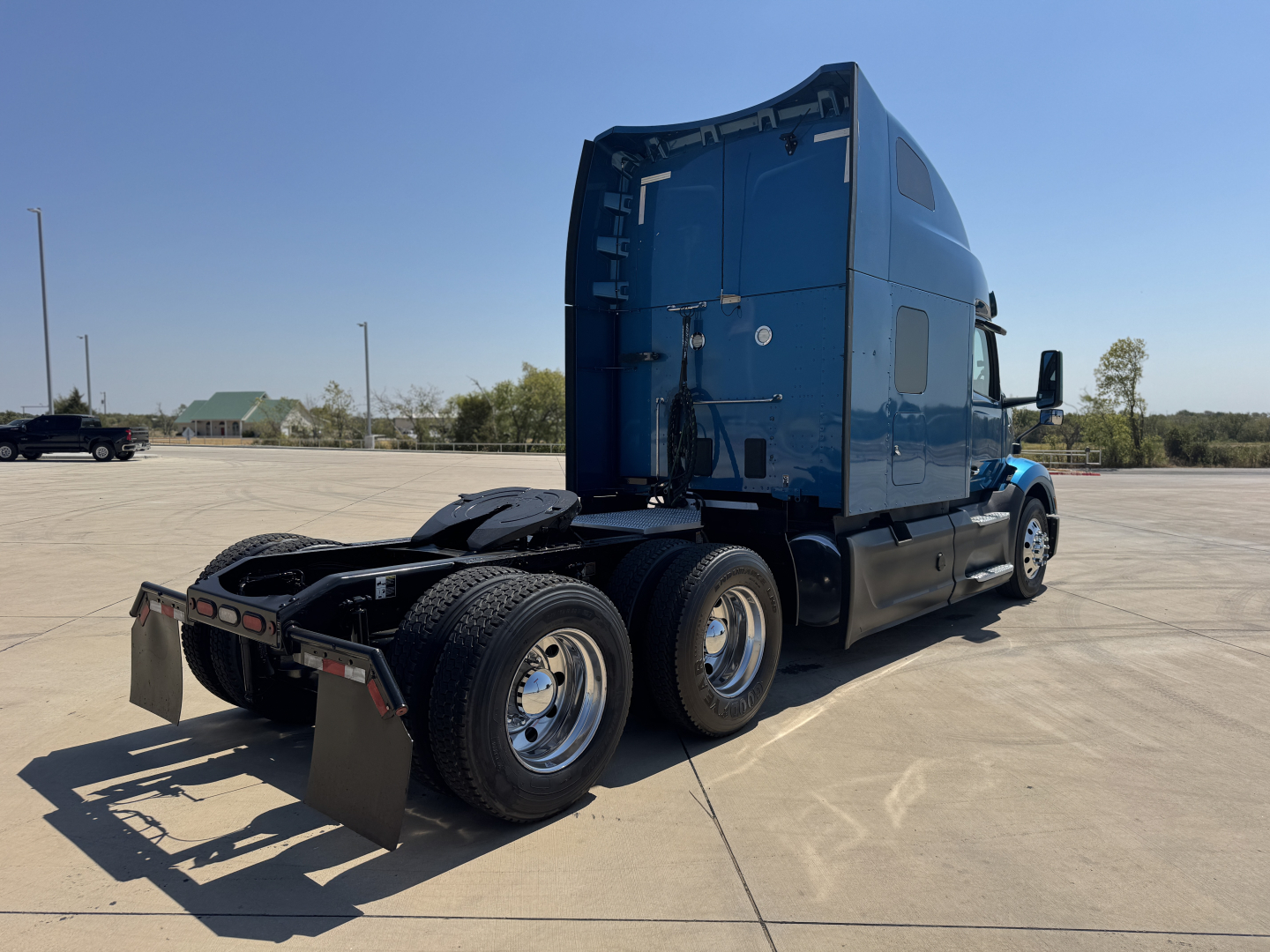 Peterbilt 579 tractor truck rear and side view showing sleeper cab and dual rear axles.