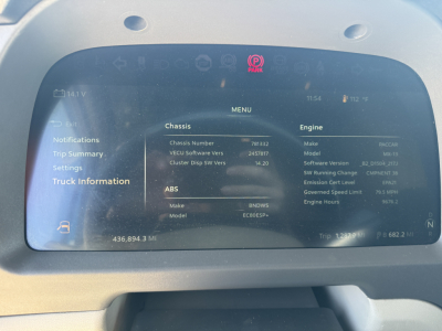 Truck dashboard display showing vehicle information: chassis number 781832, engine make and model BMW? BD? with ABS, trip data, and settings. The screen shows menu items and vehicle VIN-like details.