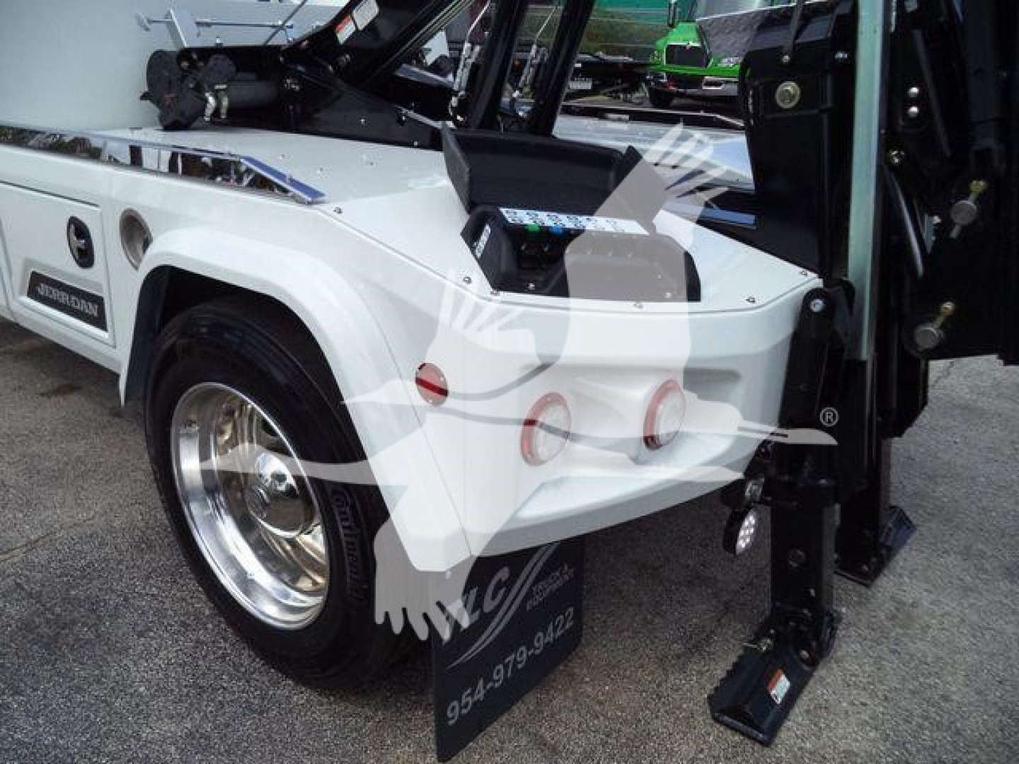 Truck rear side showing white International MV with winch, tail lights, and extended black step, stock number J86683FM.