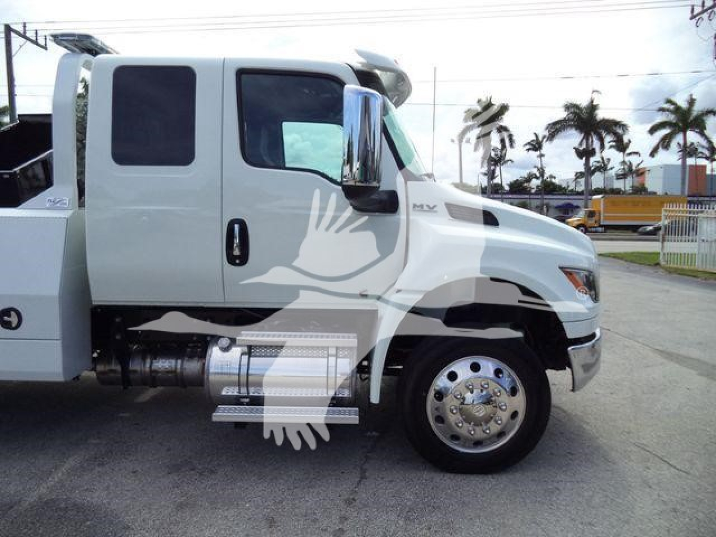 International MV truck side view with winch category, stock number J86683FM, dual cab, white exterior.