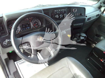 Interior view of a 2025 International MV truck cabin showing steering wheel, dashboard, gauges, and center console.