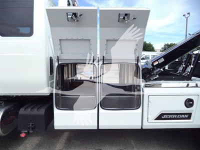Truck cab with open toolbox compartments and winch equipment, International MV, stock number J86683FM.