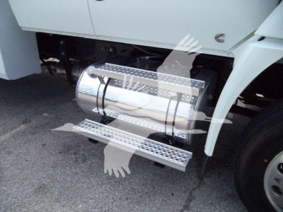 Truck side view showing chrome cylindrical fuel tank with polished steps and side access step in lower position.