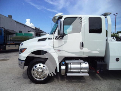 International MV truck side view showing cab and chrome fuel tank with stairs and wheel.