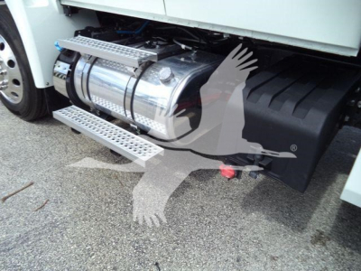 Truck side view showing stainless steel fuel tank/refueling tank with chrome steps and winch housing visible under cab.