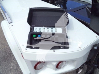 Winch control box on truck with illuminated buttons and labels; shows multiple circular symbols and green/blue buttons.