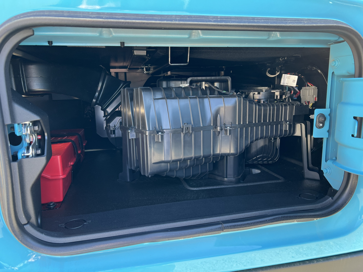Mack PR64T76H engine bay view showing air intake and radiator components inside side access panel.