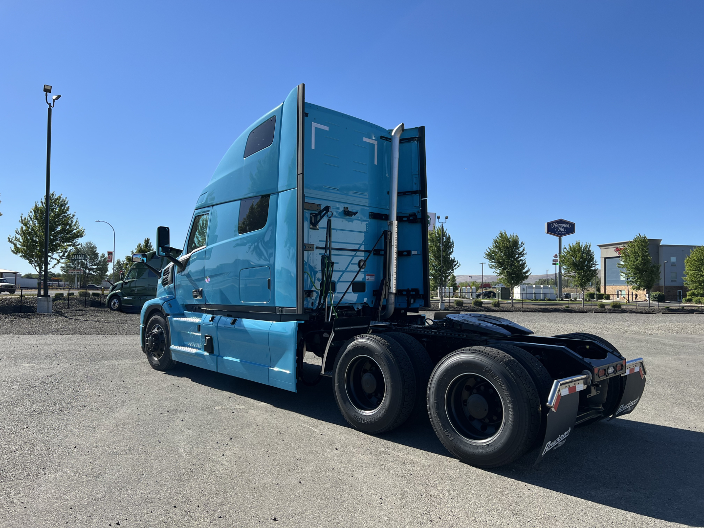 Mack PR64T76H conventional sleeper truck in blue, rear and side views showing cab, dual rear axles, and fifth wheel area.