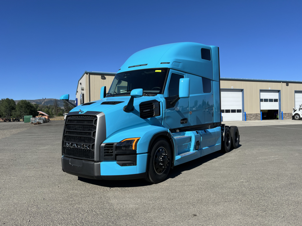 Blue 2027 Mack PR64T76H conventional sleeper truck parked outdoors showing cab and chassis details.