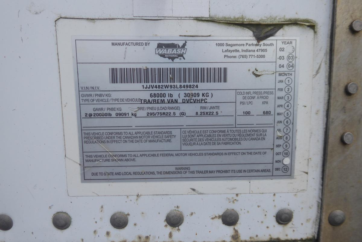 Trailer identification plate showing manufacturer Wabash, VIN 1JJV482W93L849824 with weight and compliance data.