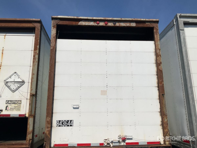Trailer bay door with white interior and brown frame showing rear of a trailer; small black number tag 843364 on door, red and white reflective strip along bottom edge.