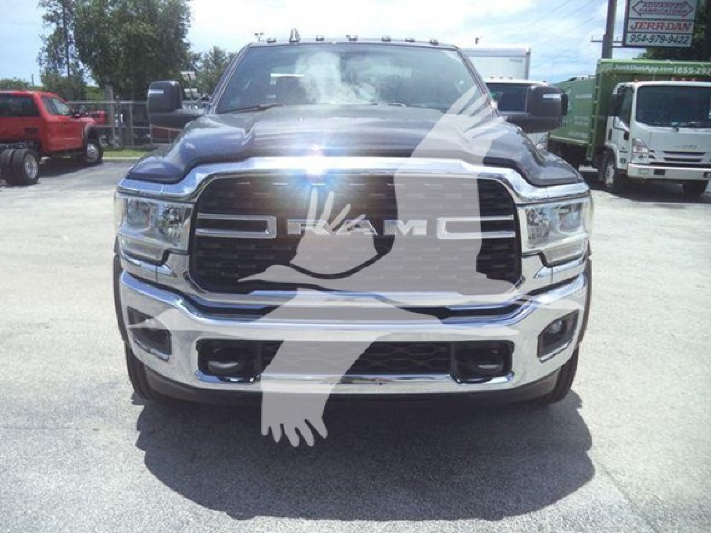 Front view of a black 2024 Ram 5500 SLT truck with chrome grille, large bumper, and winch category. watermark present.