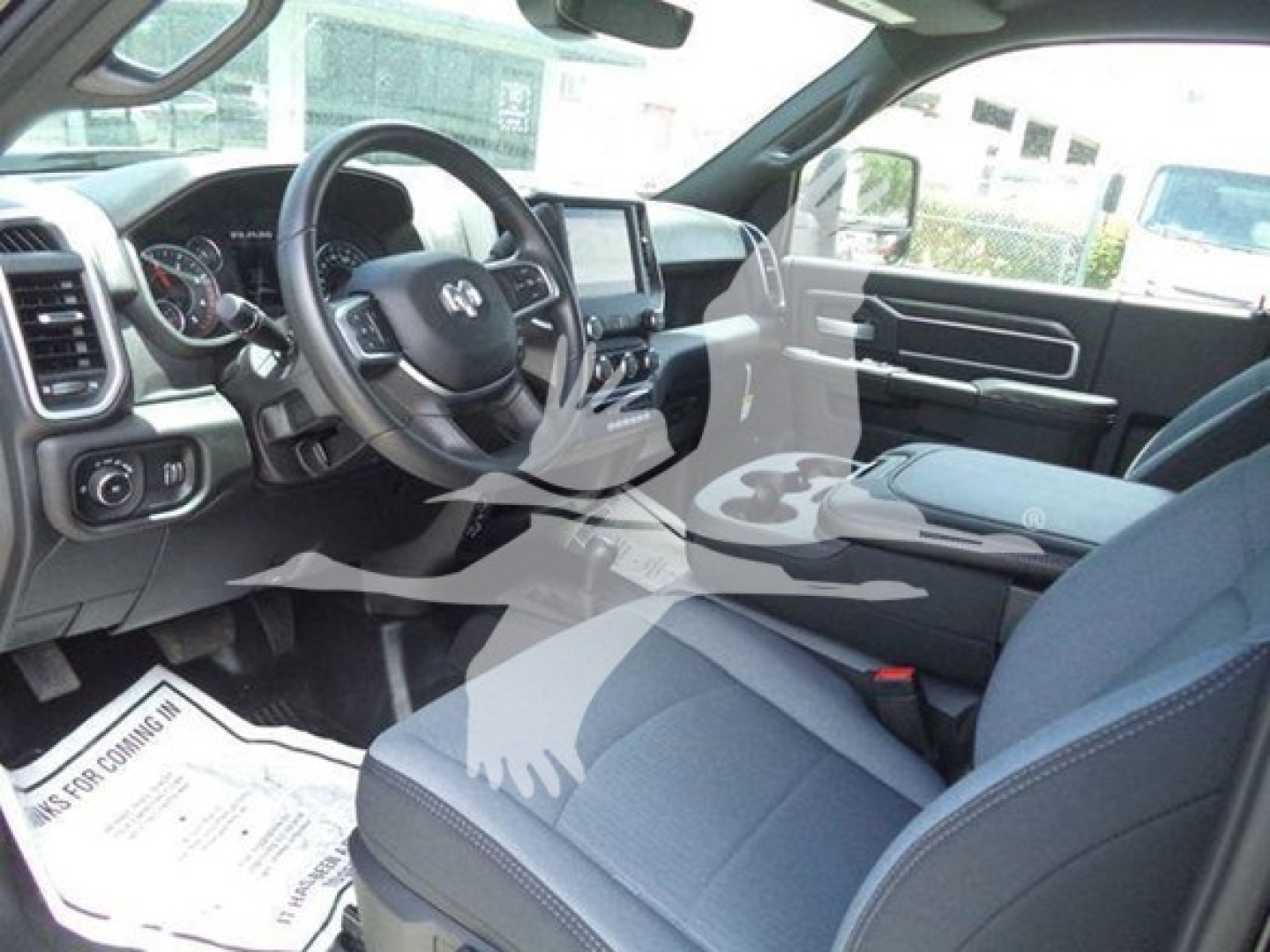 Ram 5500 SLT interior view showing steering wheel with Ram logo, center console touchscreen, and front seats.