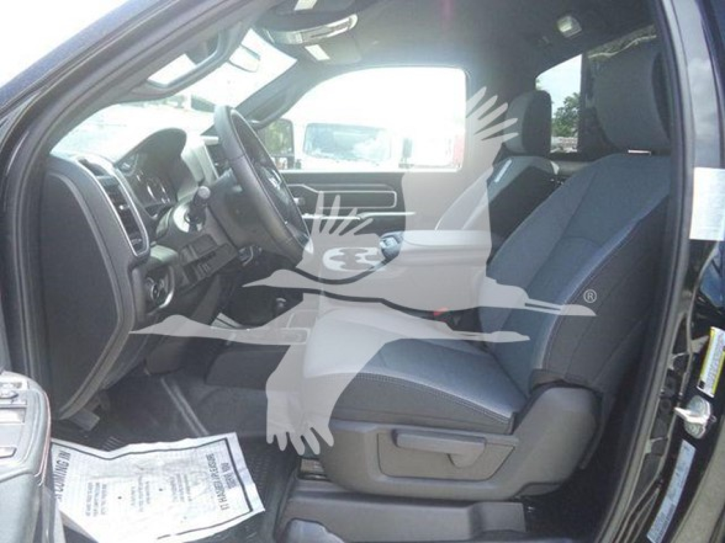 Ram 5500 SLT interior shown with front seat and dashboard visible, driver’s side door open.