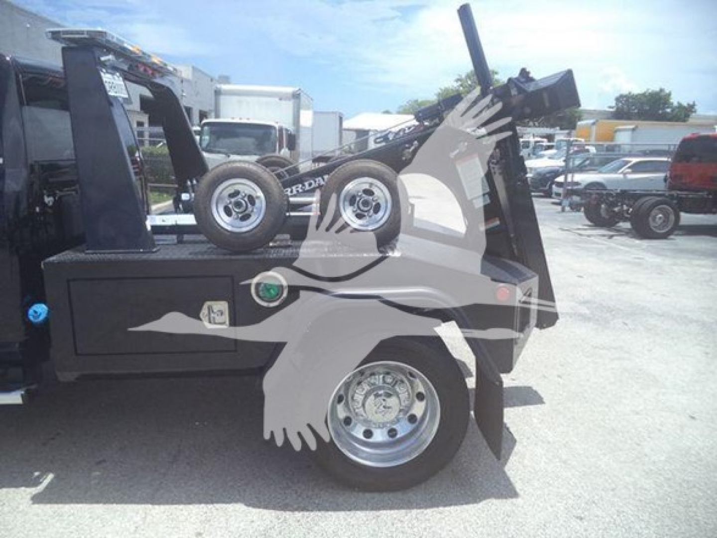 Ram 5500 SLT truck with winch equipment and spare tires in bed.