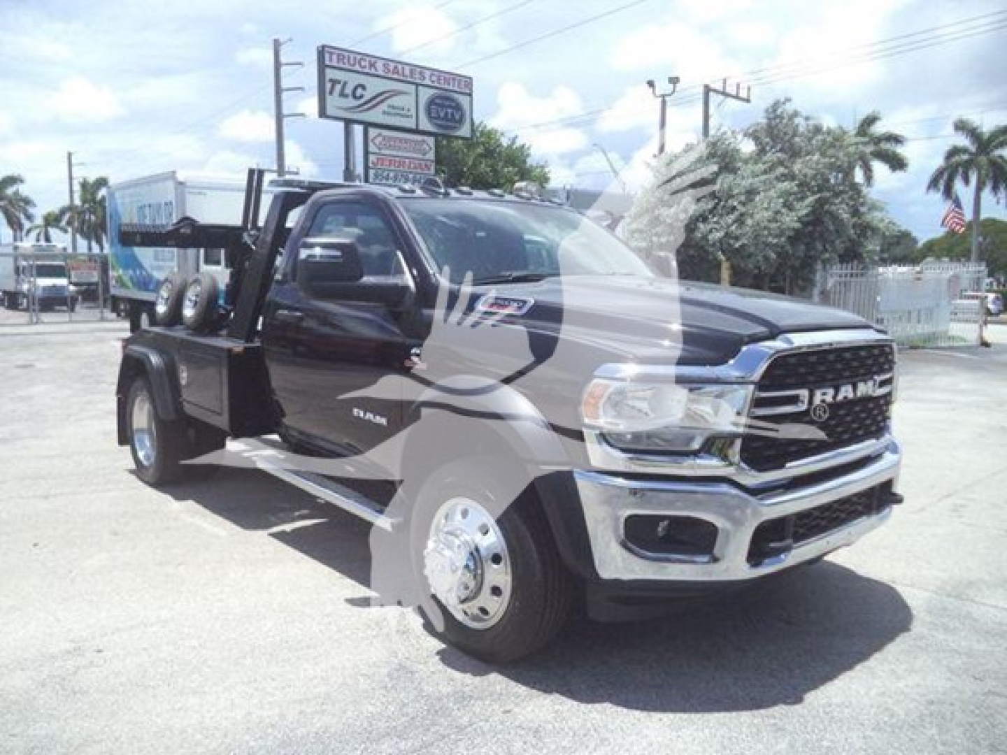 Ram 5500 tow truck towing winch equipment on truck bed with chrome bumper and black body, VIN 3C7WRNDL3RG240088