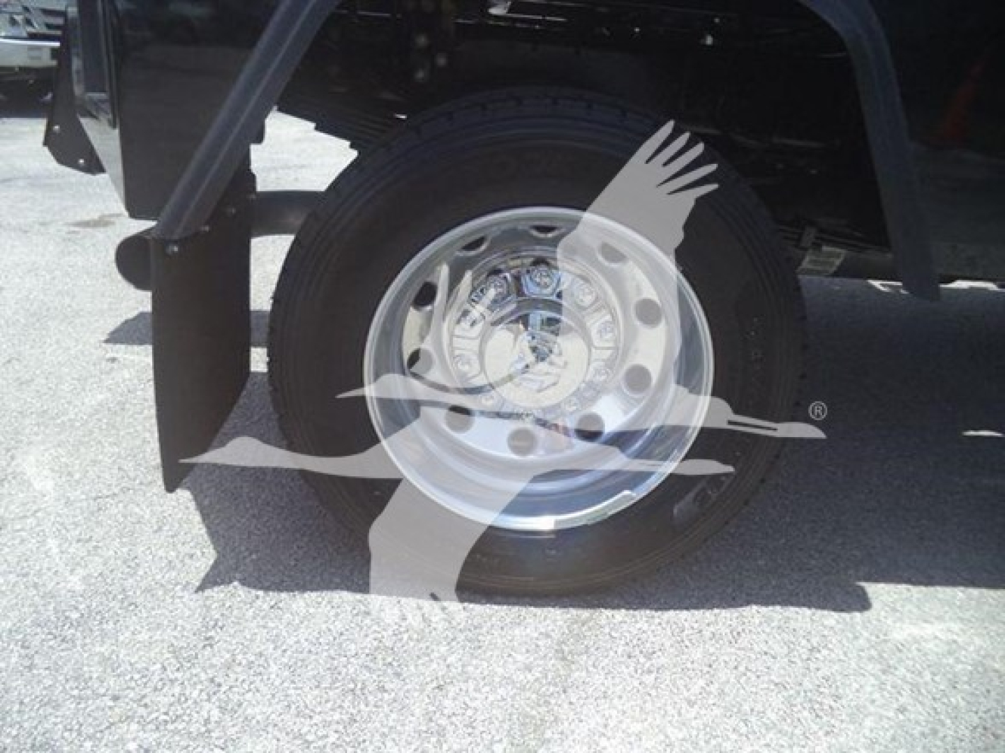 Ram 5500 wheel and tire view under front fender showing chrome steel wheel and tire sidewall.