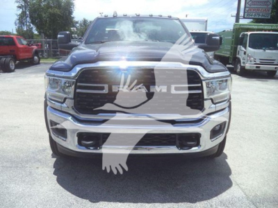 Front view of a black 2024 Ram 5500 SLT truck with chrome grille, large bumper, and winch category. watermark present.