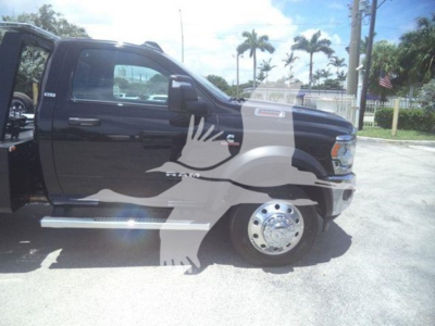 Truck side view showing 2024 Ram 5500 SLT with black paint and watermark across image.