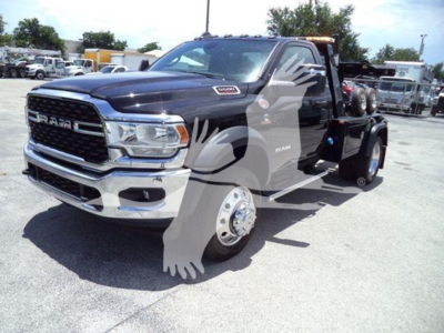 Ram 5500 truck in a dealership lot showing front grille with RAM emblem and dual rear wheels, dark blue color, winch category.