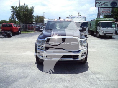 Ram 5500 SLT front view showing Dodge RAM grille and emblem, white truck in dealership lot with other vehicles in background