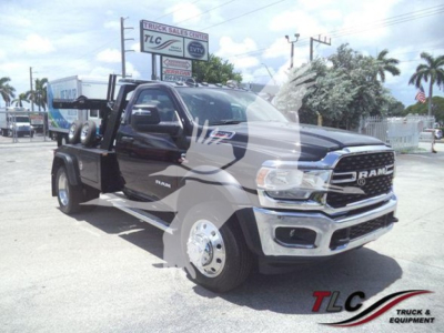 Ram 5500 tow truck in showroom setup showing front grille and winch equipment with TLC Truck Sales in background.