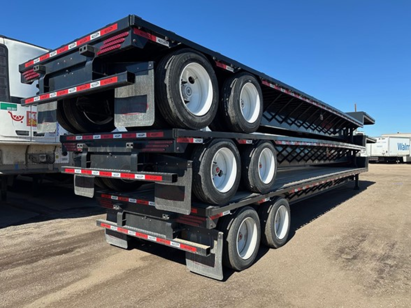 Dura Haul closed tandem drop deck trailer stacked three levels with multiple axles and tires visible.
