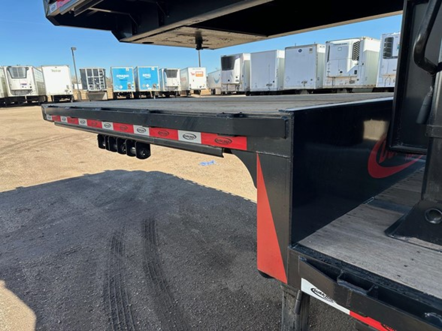 Open view of a Dura Haul closed tandem drop deck trailer showing underside with reflective tape and support legs.