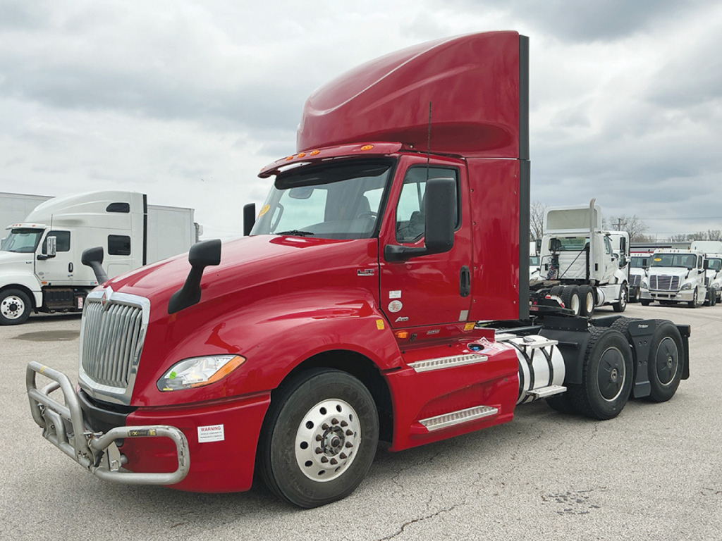 Red 2021 International LT625 daycab tractor chassis shown in profile with sleeper cab and dual rear axles, no trailer attached.