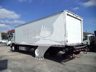 Isuzu FTR box truck in-view showing side and rear; VIN label not readable; generic truck yard background.
