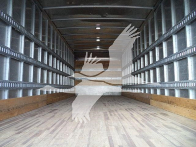 Isuzu box truck interior showing wooden floor and metal side walls with overhead lighting.