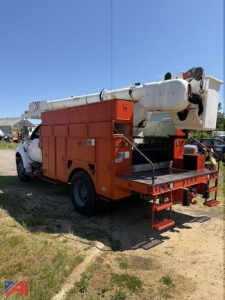 Bucket truck back view showing orange utility body and white boom arm. Side compartments with storage, rear access step, and stabilizing outriggers. Clear blue sky.