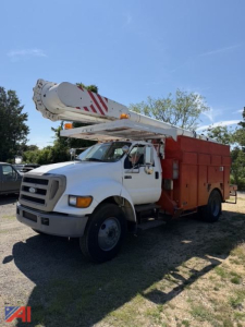 Bucket truck with white cab and red utility body, extending boom on top, 2007 Ford F750 bucket truck in a lot.