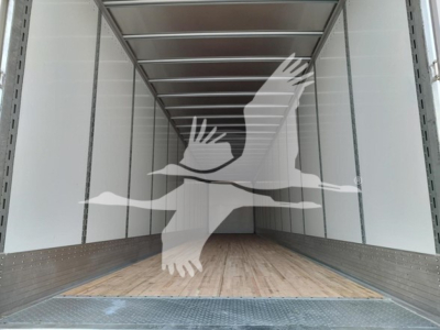 Inside cargo trailer showing empty box with wooden floor and metal sidewalls.