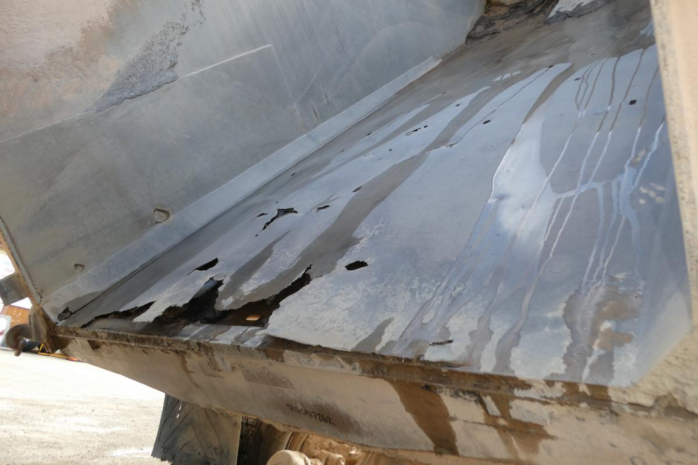 Dump truck bed interior showing metal surface with worn paint and residue in a Peterbilt 357 dump truck.