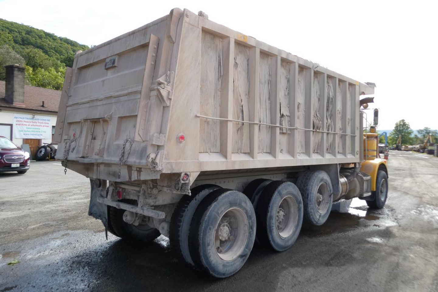 1988 Peterbilt 357 dump truck rear three-quarter view showing large dump bed and dual rear axles.