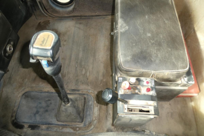 Peterbilt 357 cab interior showing gear shifter and auxiliary control box with levers and switches.