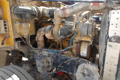 Peterbilt 357 dump truck engine bay showing hoses, air intake, and turbo components