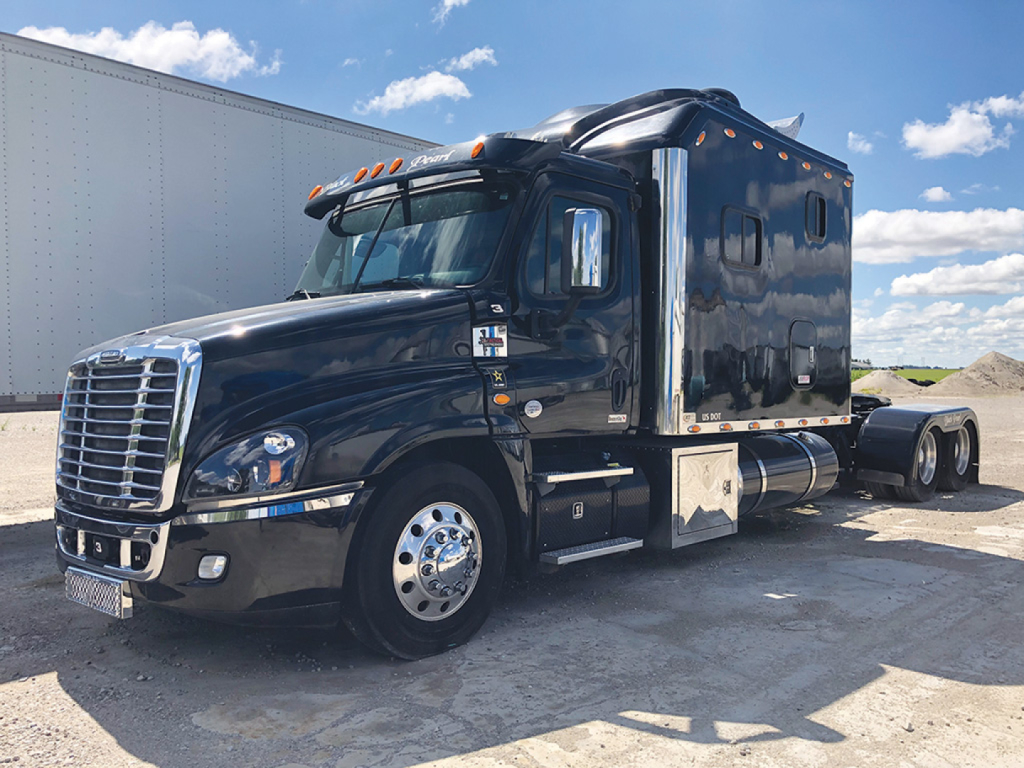 Truck cab: 2014 Freightliner Cascadia125 sleeper with glossy black finish, chrome grille, and dual rear axles. Side view showing side fuel tank, steps, and sleeper compartment.