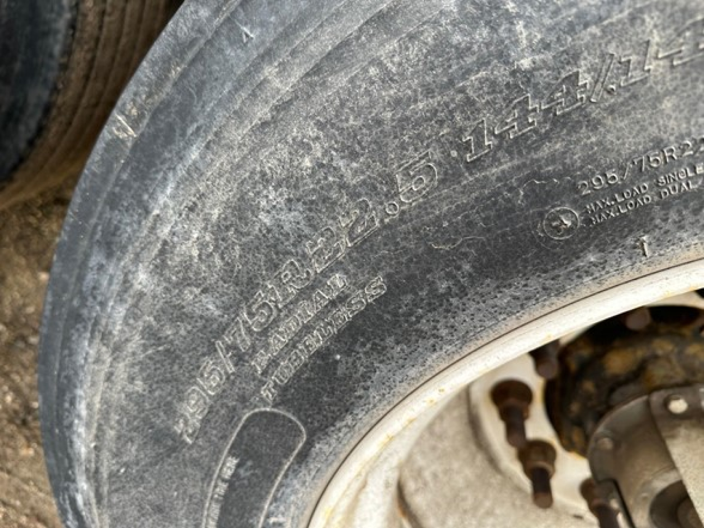 Tire tread and sidewall with visible markings on an 2018 Fontaine Velocity flatbed trailer wheel area.