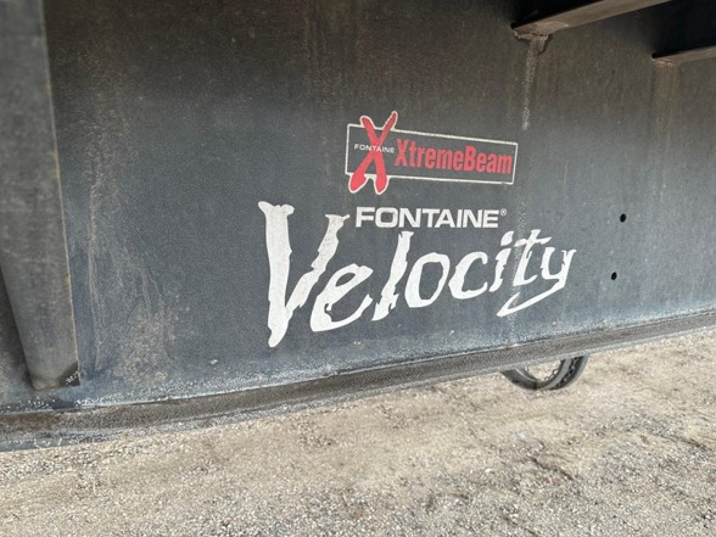 Fontaine Velocity logo on flatbed trailer side showing XtremeBeam and Fontaine Velocity branding.