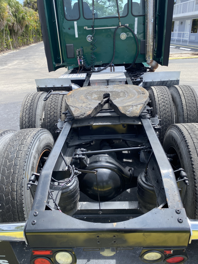 Peterbilt 579 chassis and rear view showing dual rear axles and fifth wheel with frame components visible.