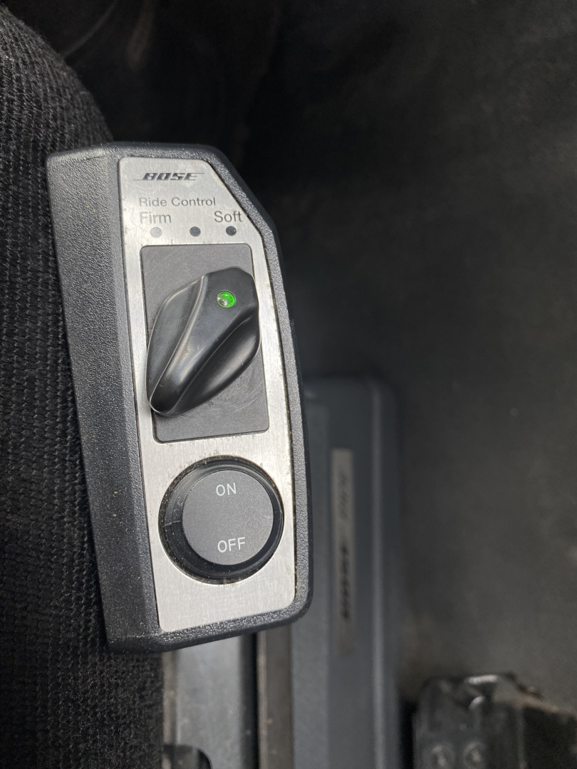 Peterbilt 579 interior throttle control switch panel with ride control firmness selector and ON/OFF switch.